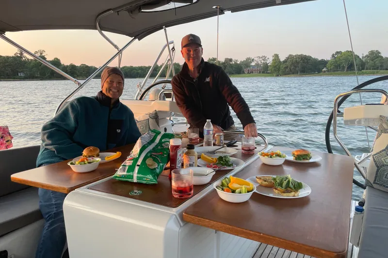 Slide: The Image of Two people enjoying a meal on a 2019 Jeanneau 51 sailboat. - 41