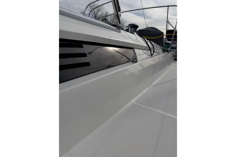 Slide: The Image of 2019 Jeanneau 51 sailboat deck, showcasing sleek design and modern features. - 53