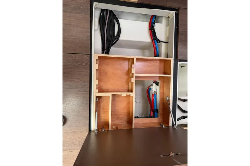 Slide: The Image of Interior view of 2019 Jeanneau 51 yacht showing wooden cabinetry and plumbing. - 55