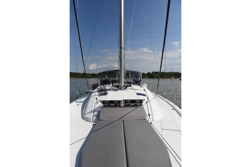 Slide: The Image of 2019 Jeanneau 51 sailboat deck view on calm water under blue sky. - 6