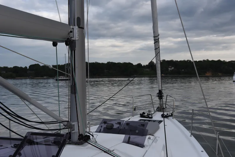 Slide: The Image of 2019 Jeanneau 51 sailboat on calm water under cloudy skies. - 8
