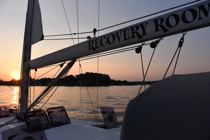 Slide: The Image of 2019 Jeanneau 51 sailboat at sunset on calm waters. - 9