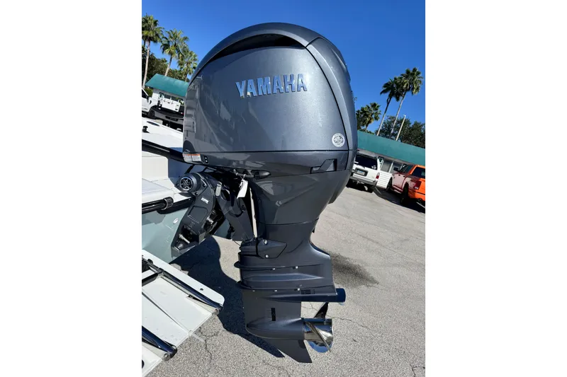 Slide: The Image of Yamaha outboard motor on a 2026 Frontier 2104 boat, parked outdoors. - 14