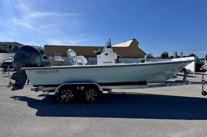 Slide: The Image of 2026 Frontier 2104 boat on trailer, featuring Yamaha outboard motor, parked outdoors. - 6