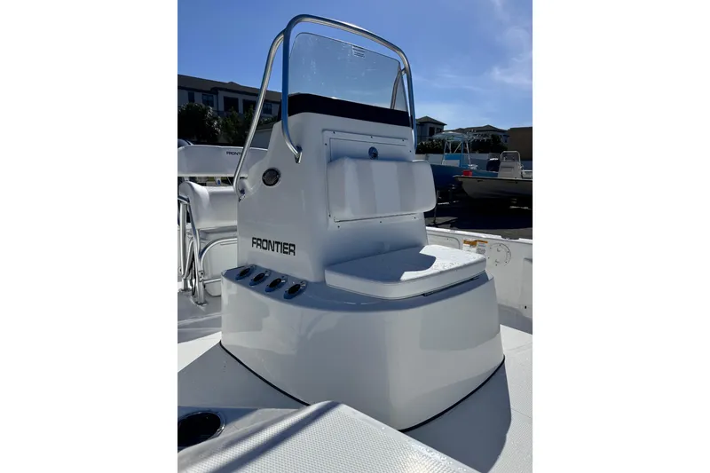 Slide: The Image of 2026 Frontier 2104 boat console with seating, sleek design under clear blue sky. - 9