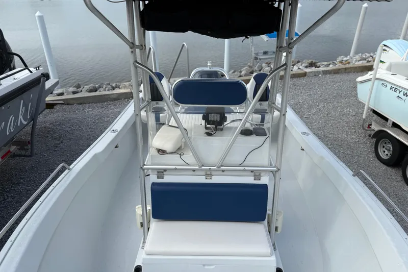 Slide: The Image of 1998 Cape Horn 19 CC boat interior with blue seating, docked by the water. - 12