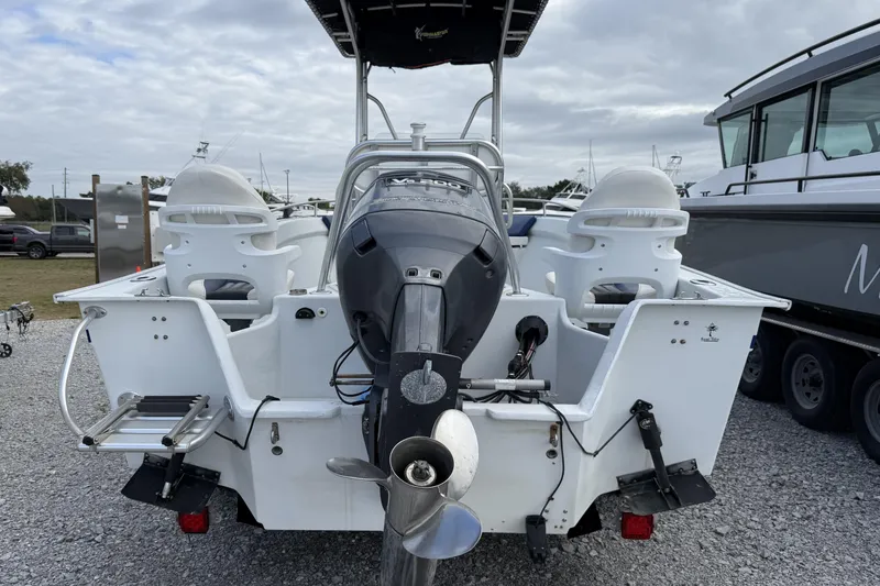 Slide: The Image of 1998 Cape Horn 19 CC boat with outboard motor, parked on gravel. - 4