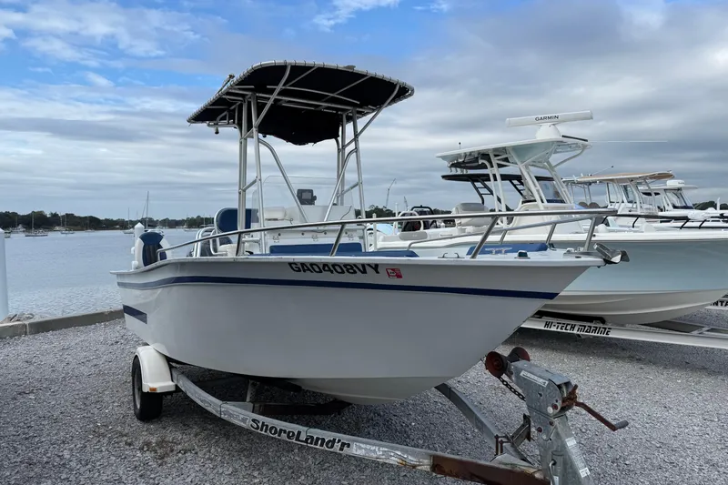 Slide: The Image of 1998 Cape Horn 19 CC boat on trailer by the waterfront, under a cloudy sky. - 8