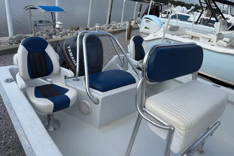 Slide: The Image of 1998 Cape Horn 19 CC boat interior with blue and white seating, docked by the water. - 16