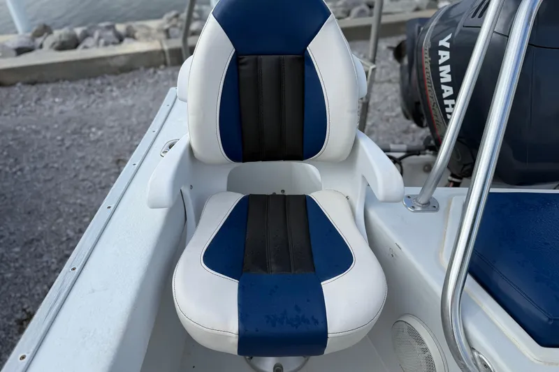 Slide: The Image of 1998 Cape Horn 19 CC boat seat with blue and white upholstery, near Yamaha engine. - 17