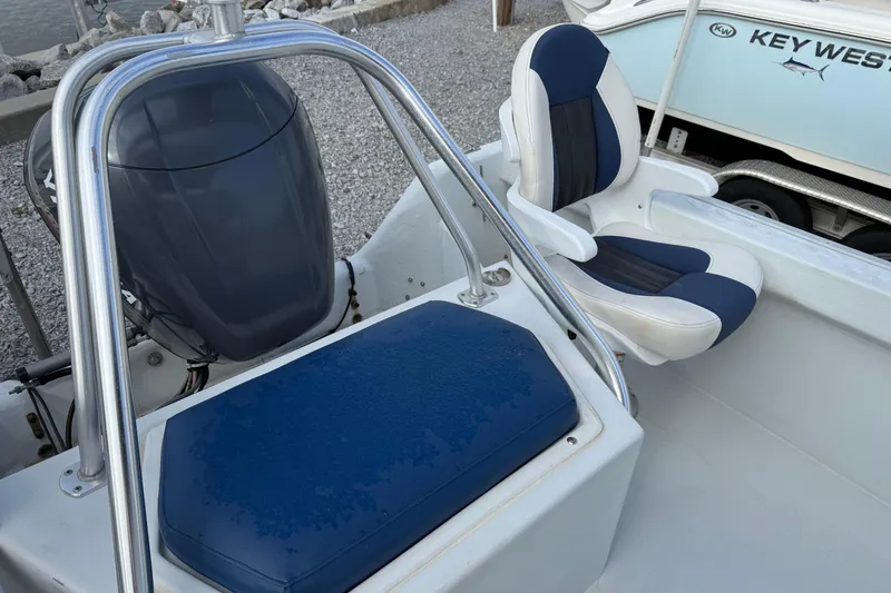 Slide: The Image of 1998 Cape Horn 19 CC boat interior with seating and engine view. - 18