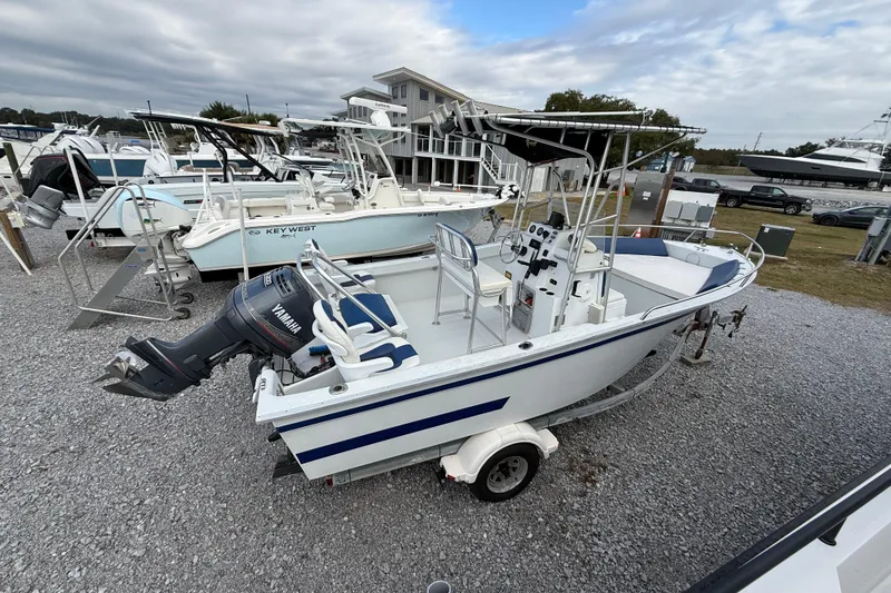 Slide: The Image of 1998 Cape Horn 19 CC boat with Yamaha outboard motor on a trailer, parked in a marina. - 7