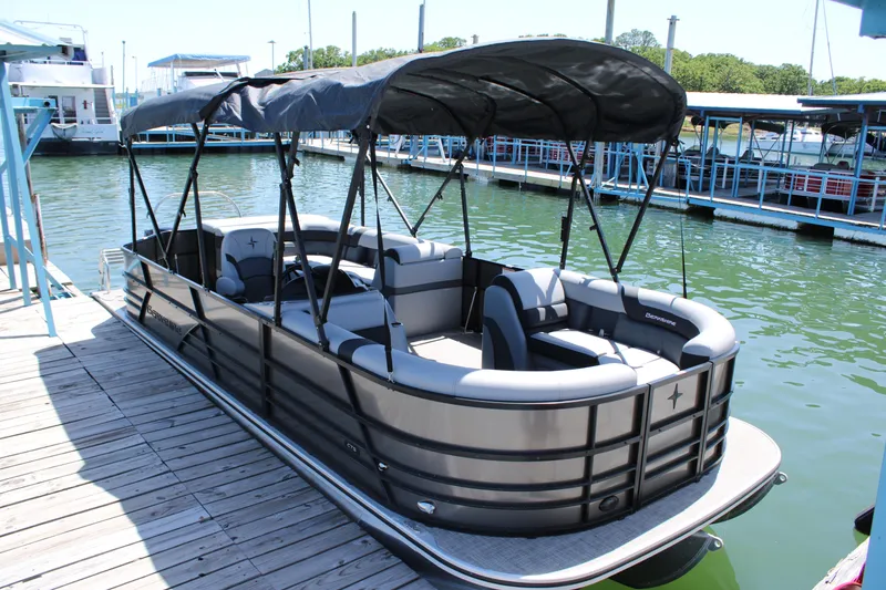 The Image of 2024 Berkshire 24CL CTS pontoon boat docked with canopy and seating. - 1