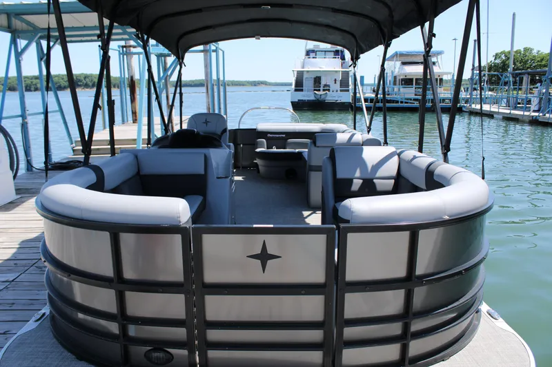 Slide: The Image of 2024 Berkshire 24CL CTS pontoon boat docked at marina, featuring spacious seating. - 5