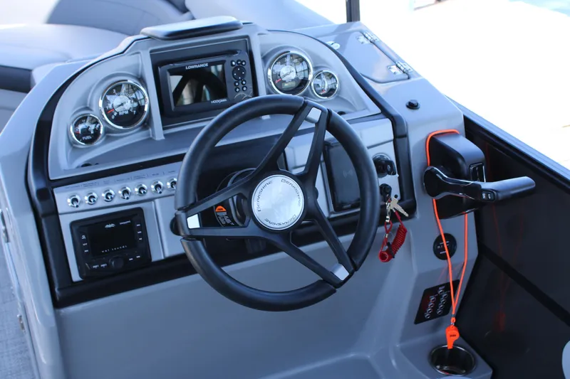 Slide: The Image of 2024 Berkshire 24CL CTS boat dashboard with steering wheel and control panel. - 8