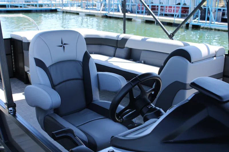 Slide: The Image of 2024 Berkshire 24CL CTS pontoon boat interior with plush seating and steering wheel. - 9