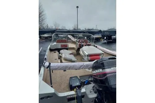 Slide: The Image of 2004 Tracker Targa 17 WT boat with seating and motor in a parking lot. - 3