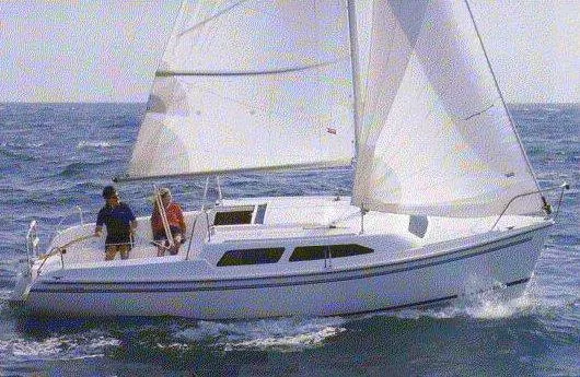 Slide: The Image of 2004 Catalina 250 WK sailboat navigating open waters with two people onboard. - 13