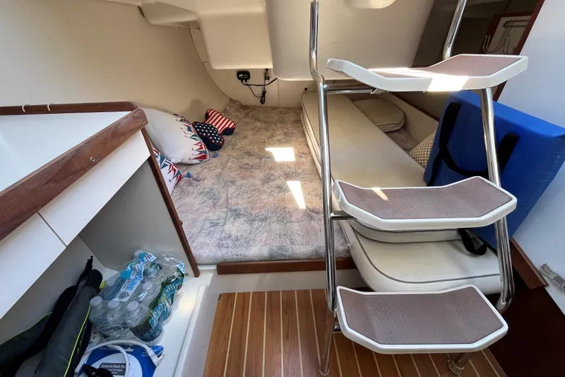 Slide: The Image of Interior cabin of a 2004 Catalina 250 WK sailboat with bedding and storage. - 6