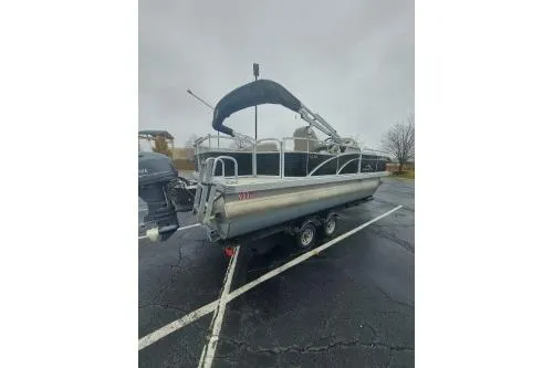 The Image of 2019 Bennington SX 20 SFX pontoon boat on trailer in parking lot. - 0