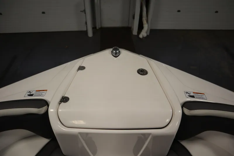 Slide: The Image of 2020 Yamaha AR210 boat bow with storage compartment and safety labels. - 11