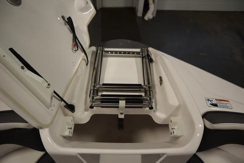 Slide: The Image of 2020 Yamaha Boats AR210 bow storage compartment with ladder. - 12