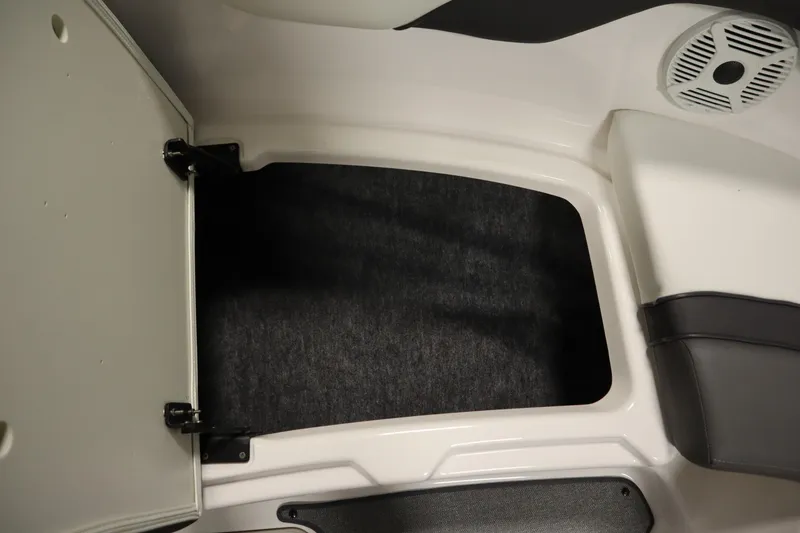 Slide: The Image of 2020 Yamaha AR210 boat storage compartment with speaker and cushioned seating. - 14