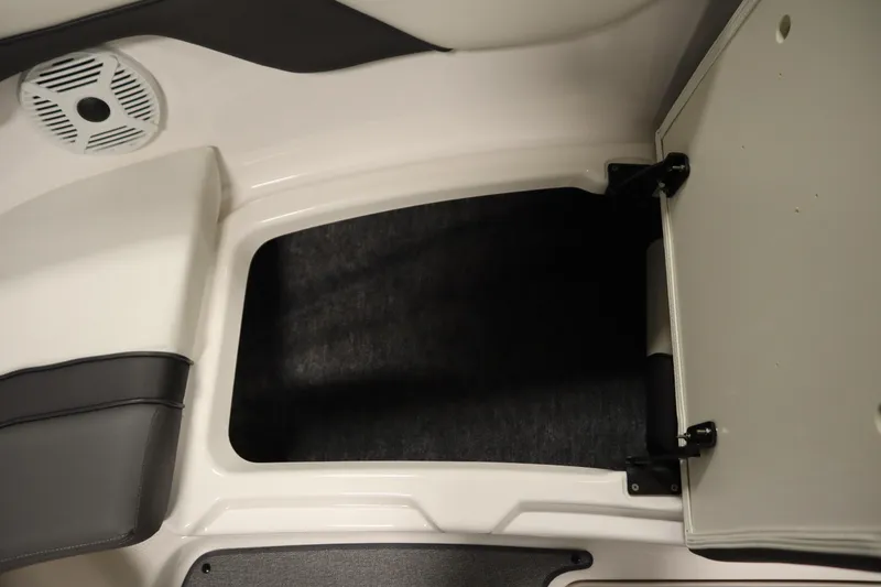 Slide: The Image of 2020 Yamaha AR210 boat storage compartment with open hatch and speaker. - 16