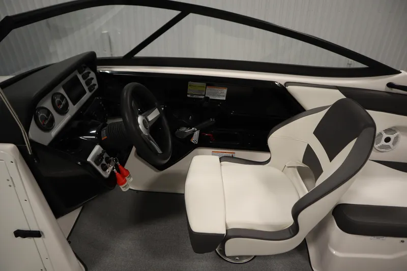 Slide: The Image of 2020 Yamaha Boats AR210 cockpit with steering wheel and captain's chair. - 18