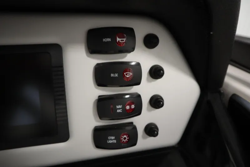 Slide: The Image of Control panel of 2020 Yamaha AR210 boat with labeled switches for horn, bilge, navigation, and lights. - 23