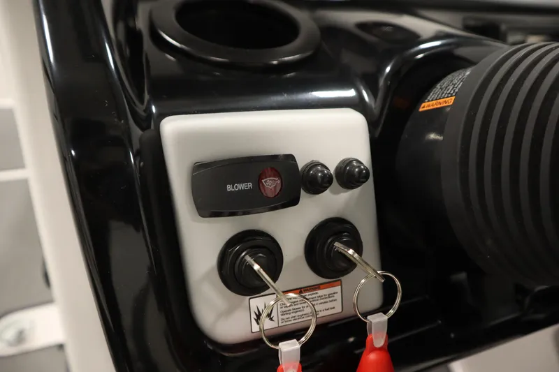Slide: The Image of Control panel of a 2020 Yamaha Boats AR210 with ignition keys and blower switch. - 27