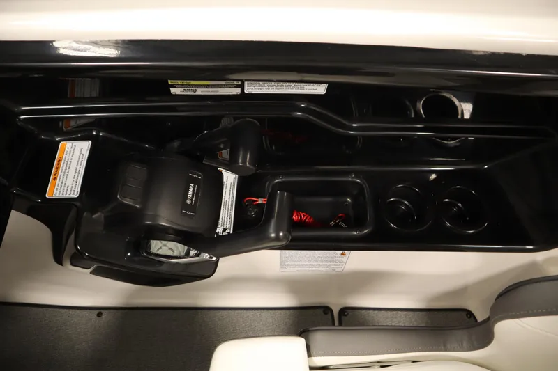 Slide: The Image of 2020 Yamaha AR210 boat dashboard with controls and cup holders. - 28