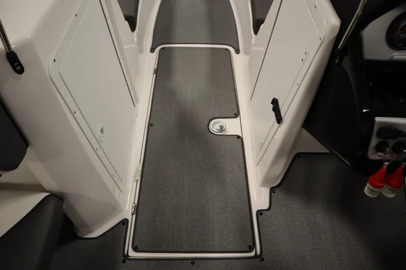 Slide: The Image of Interior view of 2020 Yamaha AR210 boat, featuring sleek flooring and storage compartments. - 31