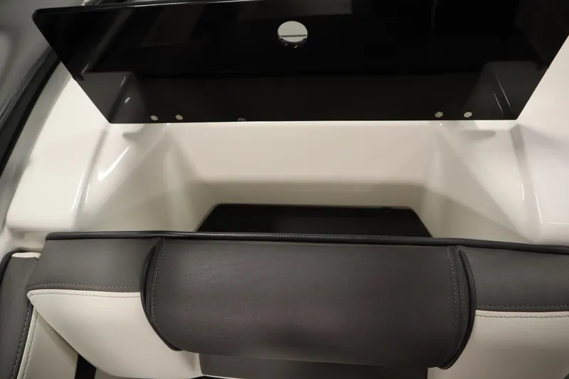 Slide: The Image of 2020 Yamaha AR210 boat interior storage compartment with sleek black and white design. - 35