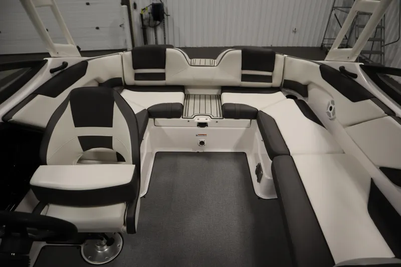 Slide: The Image of 2020 Yamaha Boats AR210 interior with sleek black and white seating design. - 36
