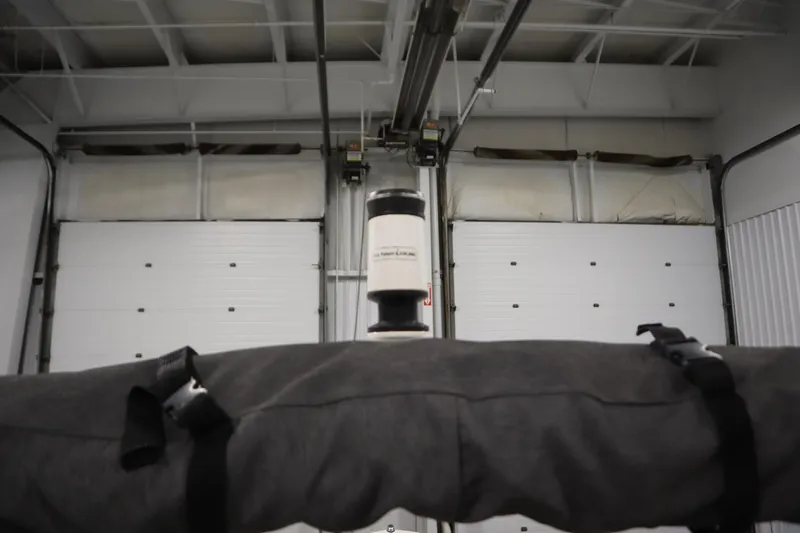 Slide: The Image of 2020 Yamaha Boats AR210 in storage with covered equipment and garage doors. - 41