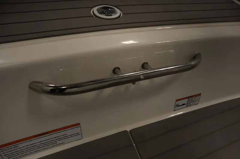 Slide: The Image of 2020 Yamaha AR210 boat interior with stainless steel handrail and safety warnings. - 44