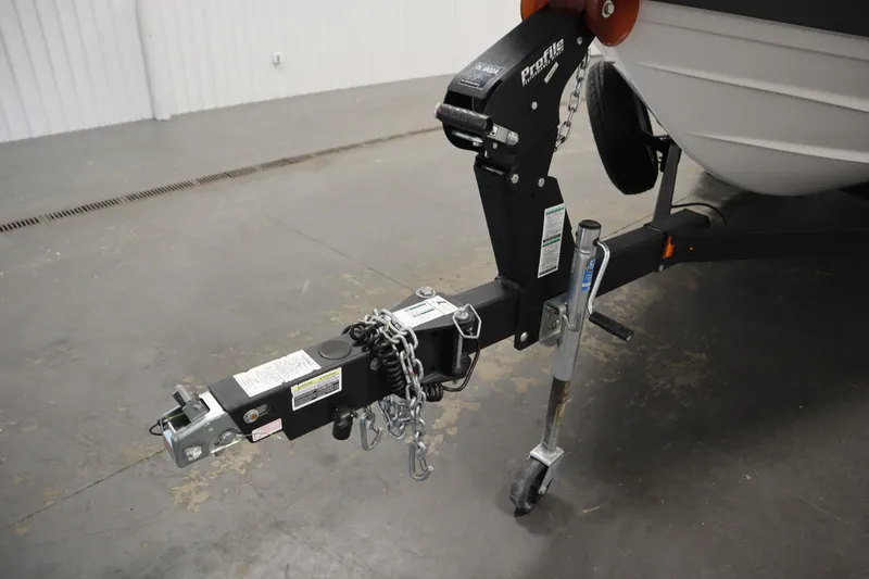 Slide: The Image of Trailer hitch of a 2020 Yamaha Boats AR210, featuring secure chains and jack stand. - 46