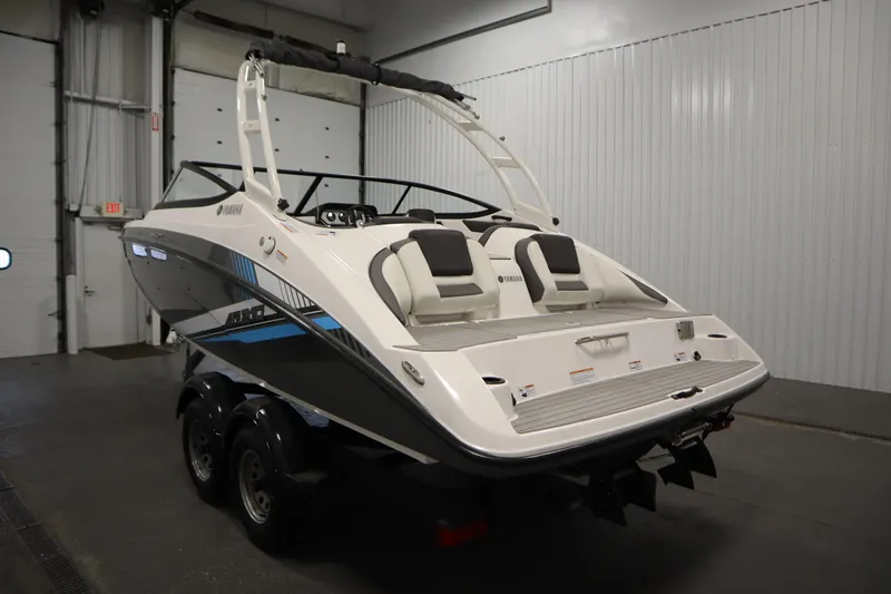 Slide: The Image of 2020 Yamaha Boats AR210 in showroom, rear view, sleek design, dual seating. - 6