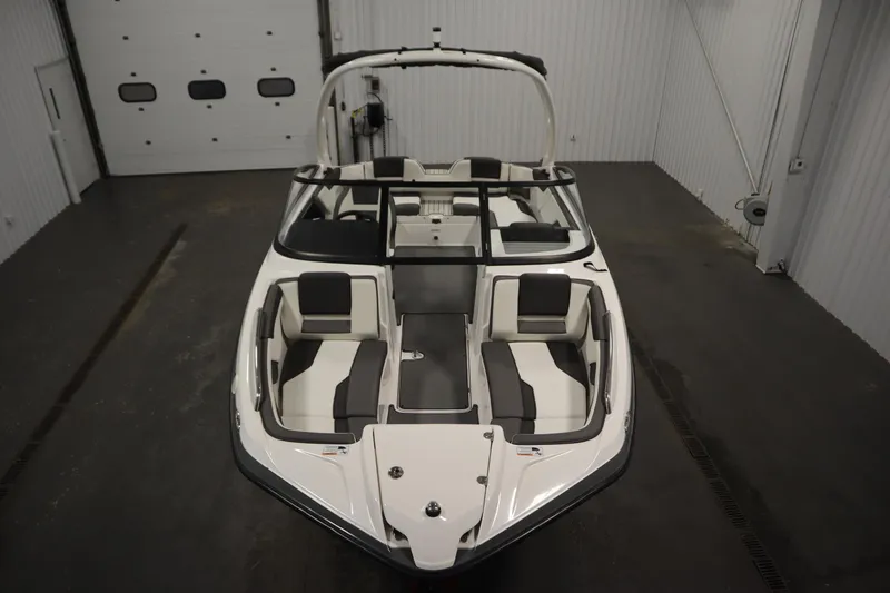 Slide: The Image of 2020 Yamaha Boats AR210 in indoor storage, showcasing sleek design and spacious seating. - 8