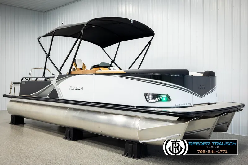 Slide: The Image of 2026 Avalon LSZ VRB pontoon boat with sleek design in showroom setting. - 3
