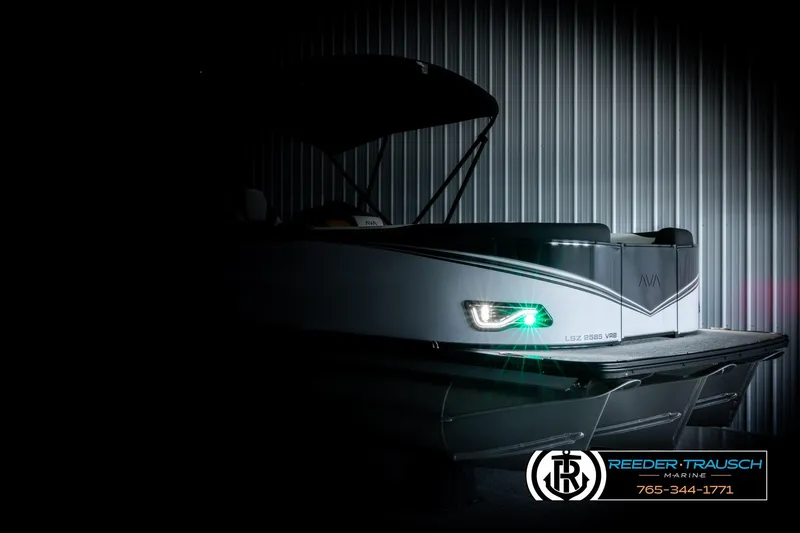 Slide: The Image of 2026 Avalon LSZ VRB boat in dimly lit showroom, showcasing sleek design and modern features. - 4