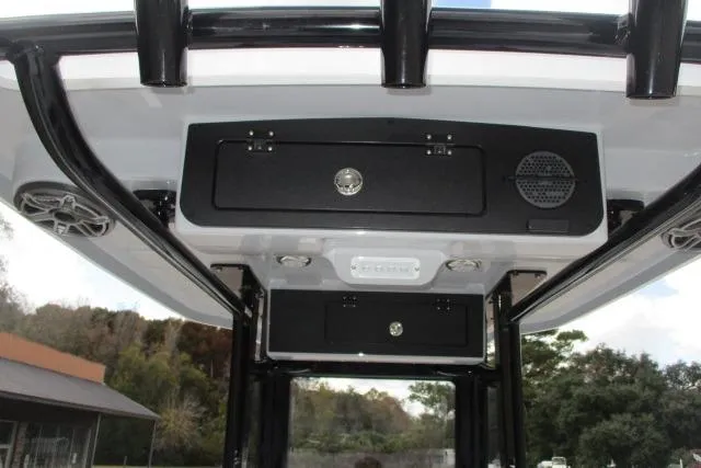 Slide: The Image of 2026 Blazer Bay MAKARIA 2600 boat on trailer, side view, cloudy sky background. - 10