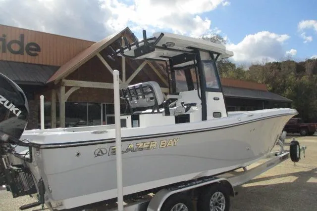 Slide: The Image of 2026 Blazer Bay MAKARIA 2600 boat on trailer under cloudy sky. - 2