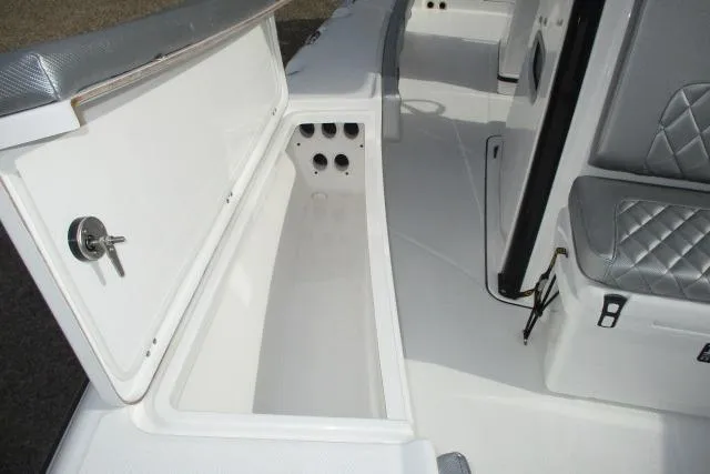 Slide: The Image of 2026 Blazer Bay MAKARIA 2600 boat with gray cushioned seating and Suzuki engine. - 21