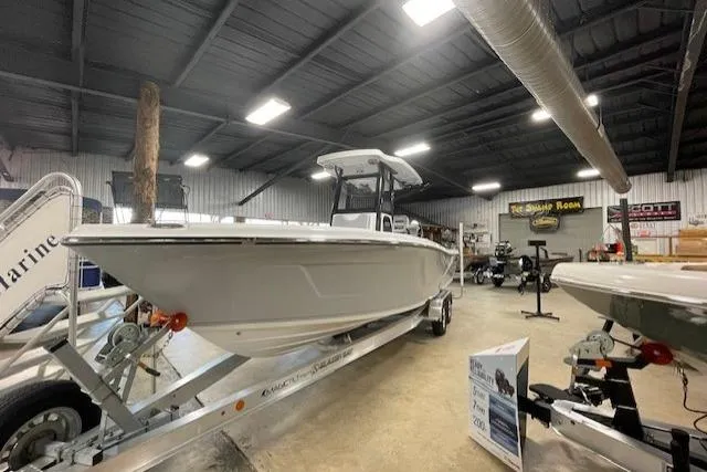 Slide: The Image of 2026 Blazer Bay Makaira 2600 boat displayed in a showroom on a trailer. - 41