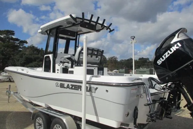Slide: The Image of 2026 Blazer Bay MAKARIA 2600 boat with rod holders and T-top against cloudy sky. - 7