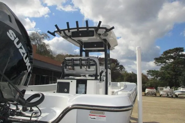 Slide: The Image of 2026 Blazer Bay MAKARIA 2600 boat with Suzuki engine on trailer, under cloudy sky. - 8