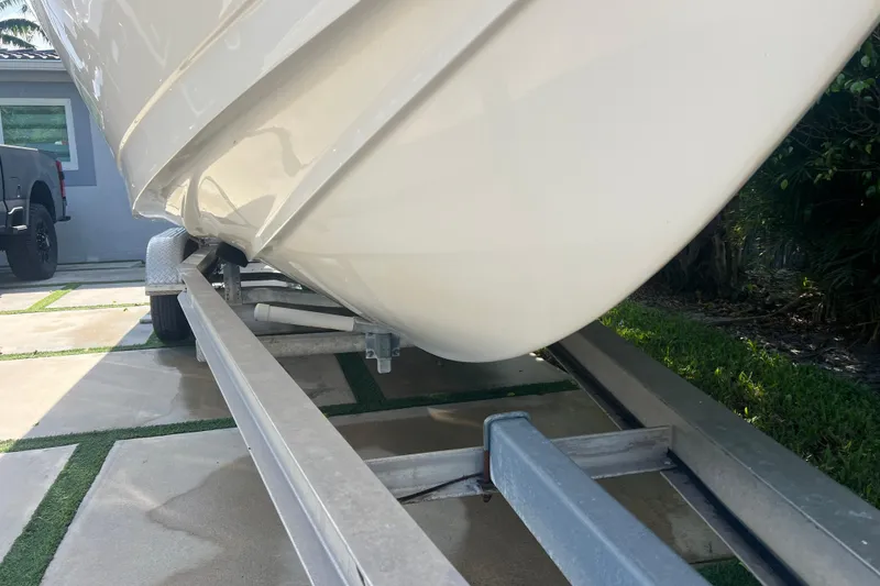 Slide: The Image of 1990 Intrepid 28 Open boat on trailer, parked in driveway. - 3