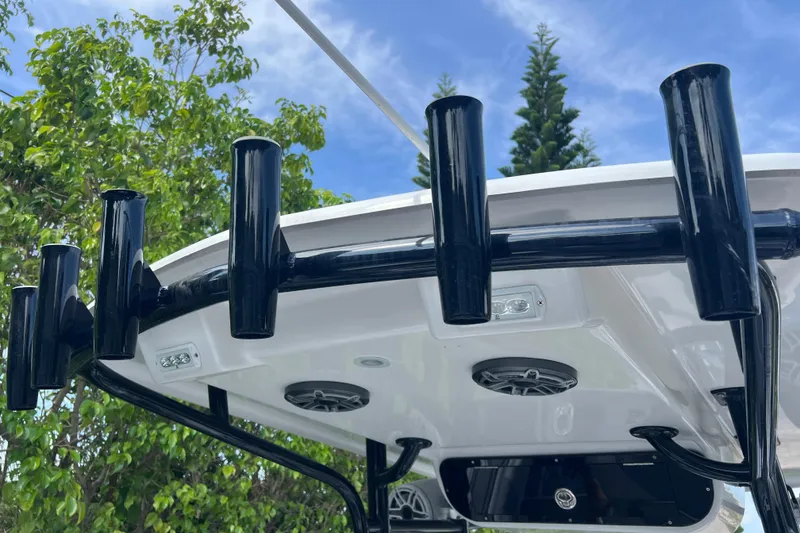 Slide: The Image of Rod holders on a 1990 Intrepid 28 Open boat against a blue sky backdrop. - 6